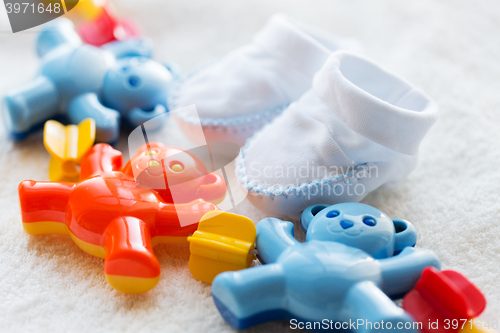 Image of close up of baby rattle and bootees for newborn