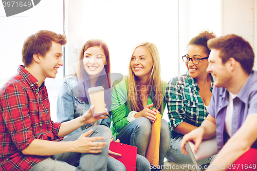 Image of students communicating and laughing at school