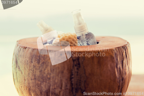 Image of bowl with moisturizing spray at hotel beach or spa
