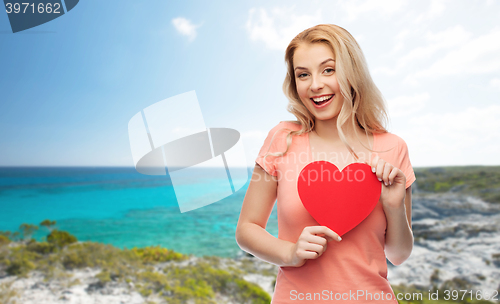 Image of happy woman or teen girl with red heart shape