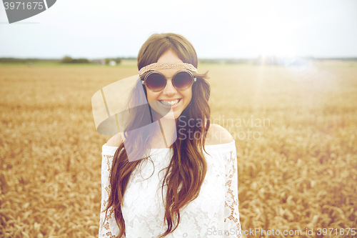 Image of smiling young hippie woman on cereal field
