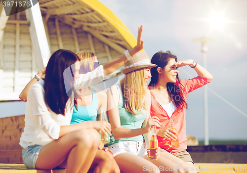 Image of girls with drinks on the beach