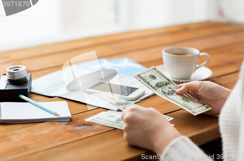 Image of close up of traveler hands counting dollar money