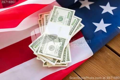 Image of close up of american flag and dollar cash money