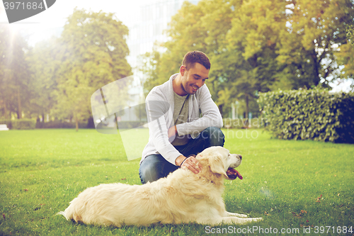 Image of happy man with labrador dog walking in city