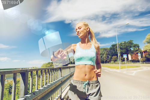 Image of smiling young woman running outdoors