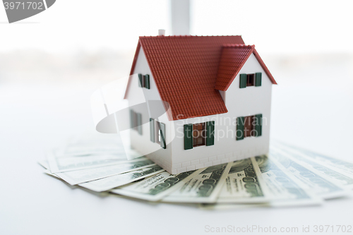 Image of close up of home or house model and money