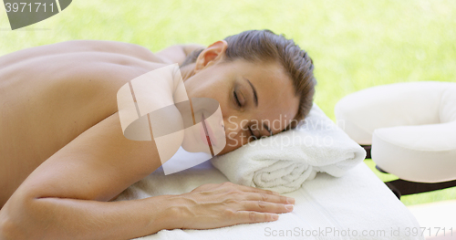 Image of Woman smiles at camera while at spa