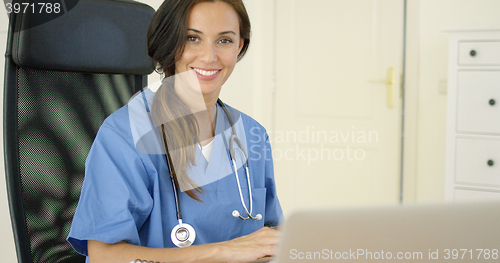 Image of Beautiful female doctor at laptop computer