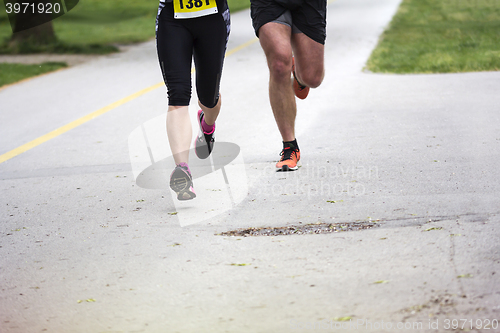 Image of Young couple running in the city park