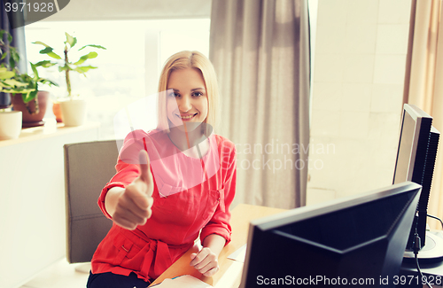 Image of happy creative female office worker with computers