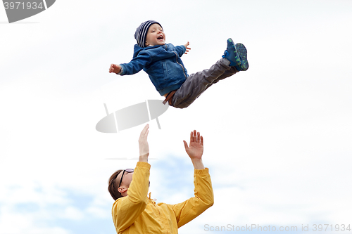 Image of father with son playing and having fun outdoors