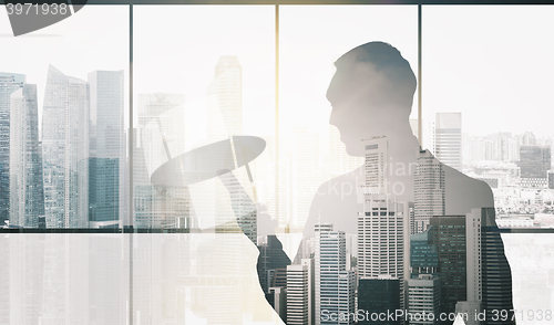 Image of silhouette of businessman with smartphone