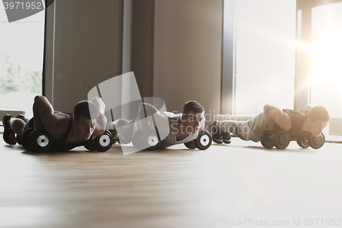 Image of group of men with dumbbells in gym