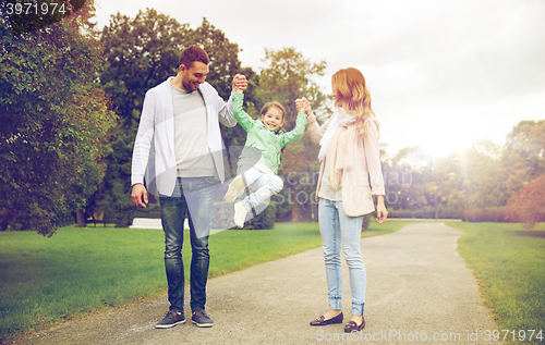 Image of happy family walking in summer park and having fun