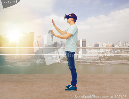 Image of happy man in virtual reality headset or 3d glasses