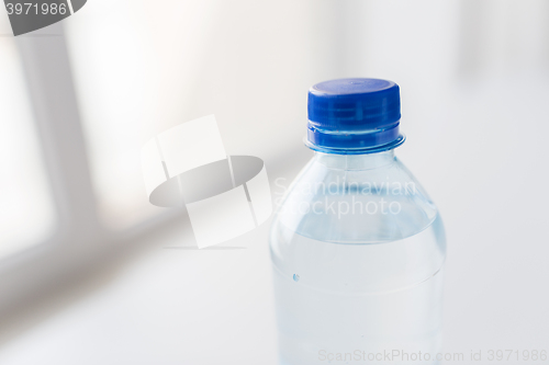 Image of close up of bottle with drinking water on table