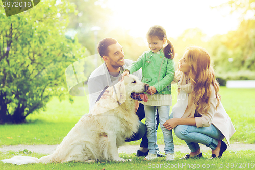 Image of happy family with labrador retriever dog in park