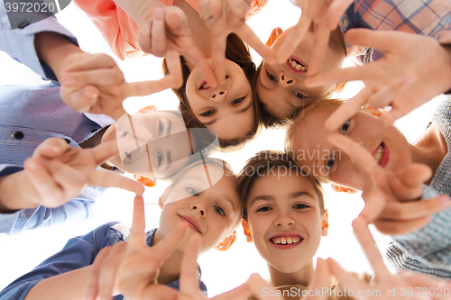 Image of happy children showing peace hand sign