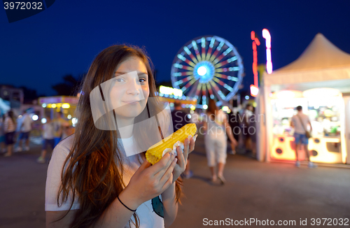 Image of teen girl eating corn