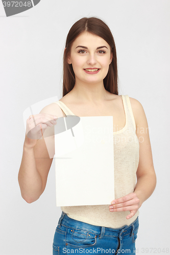 Image of Young smiling woman show blank card
