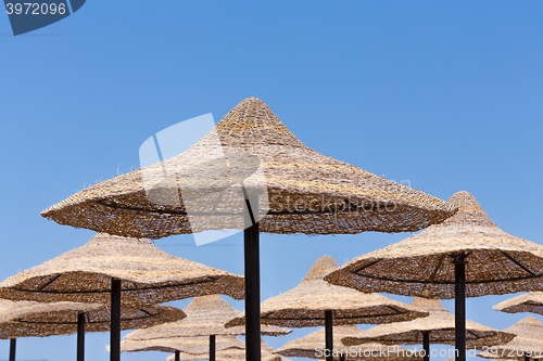 Image of Beach umbrellas and blue sky background