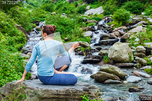 Image of Woman doing Ashtanga Vinyasa Yoga asana Marichyasana D