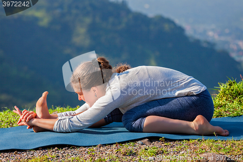 Image of Woman in Tiryam-Mukha Eka-Pada Paschimottanasana asana stretchin