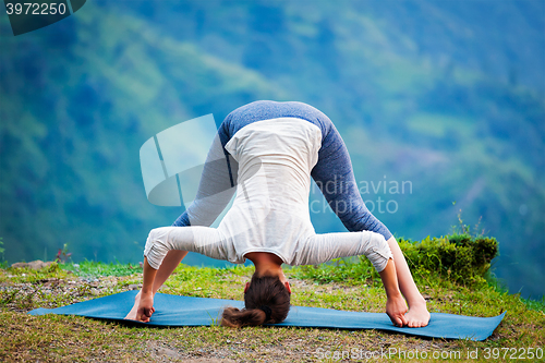 Image of Woman doing Ashtanga Vinyasa Yoga asana Prasarita padottanasana 