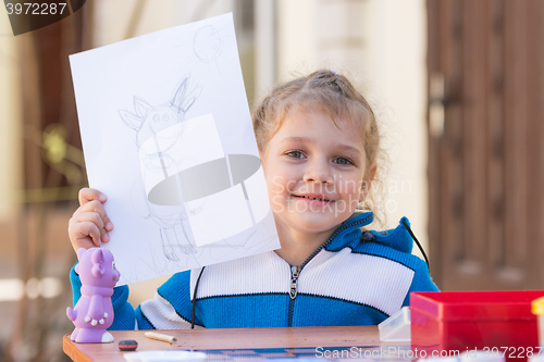 Image of Vityazevo, Russia - April 24, 2016: Girl painted Luntik at a table in the garden