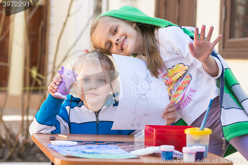 Image of Vityazevo, Russia - April 24, 2016: Two girls painted Luntik at a table in the garden