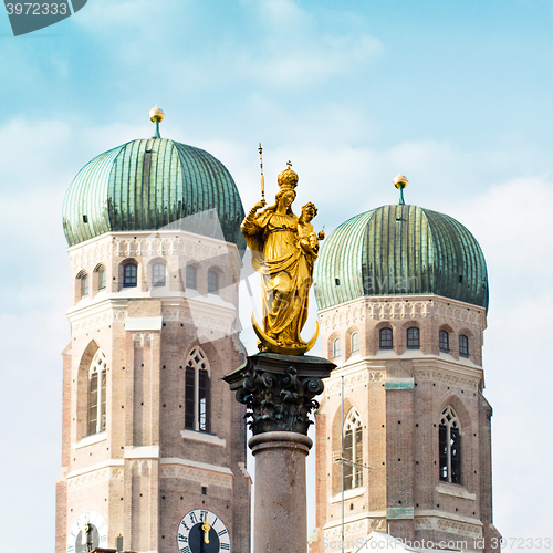 Image of The Golden Mary\'s Column opposite the towers of the Cathedral of Our Dear Lady in Munich, Germany