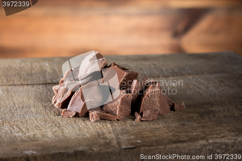 Image of Pieces of milk Chocolate on wood