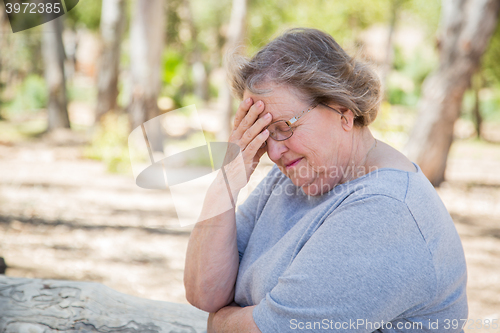 Image of Upset Senior Woman Sitting Alone