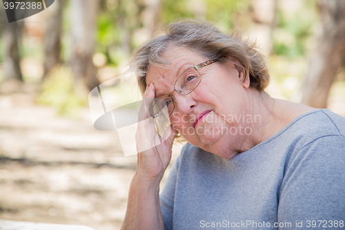 Image of Upset Senior Woman Sitting Alone