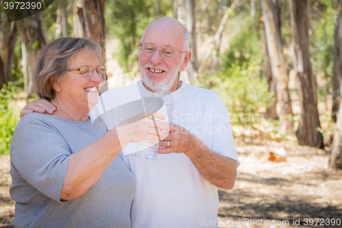 Image of Happy Healthy Senior Couple with Water Bottles