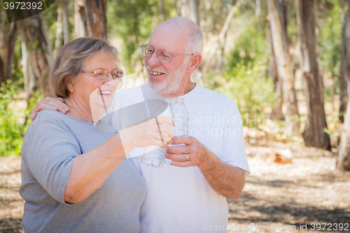 Image of Happy Healthy Senior Couple with Water Bottles