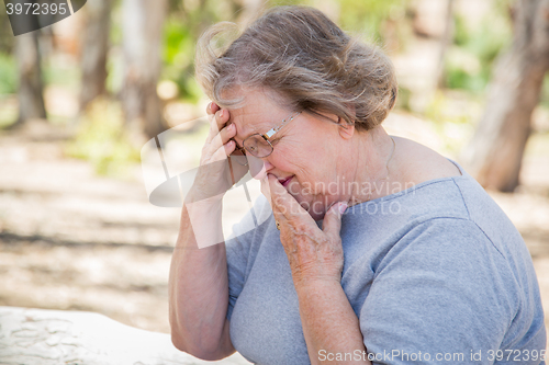 Image of Upset Senior Woman Sitting Alone