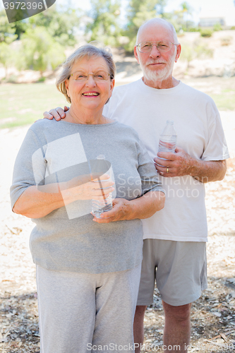 Image of Happy Healthy Senior Couple with Water Bottles