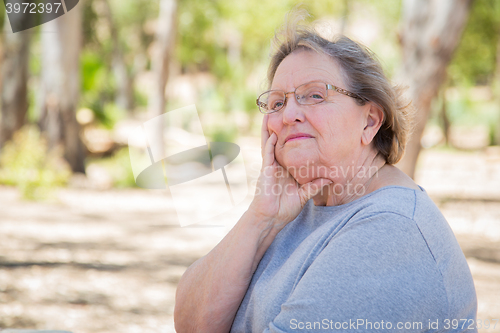 Image of Upset Senior Woman Sitting Alone
