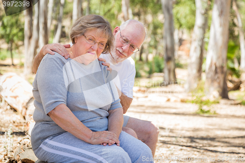 Image of Upset Senior Woman Sits With Concerned Husband Outdoors