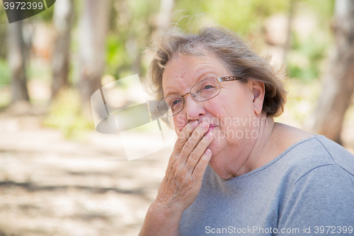 Image of Upset Senior Woman Sitting Alone