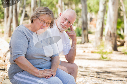 Image of Upset Senior Woman Sits With Concerned Husband Outdoors