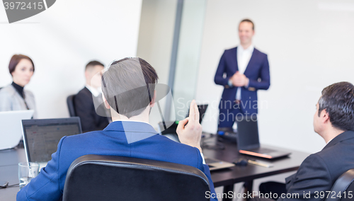 Image of Colleague asking question to business team leader.