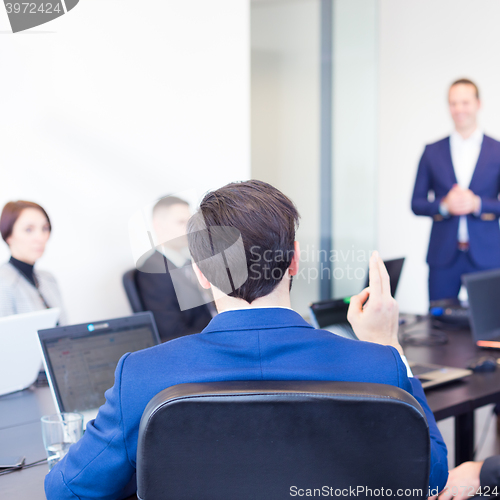 Image of Colleague asking question to business team leader.