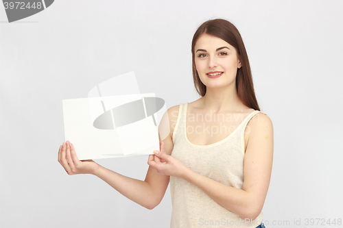 Image of Young smiling woman show blank card