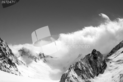 Image of Black and white winter snowy mountains in cloud