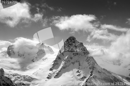 Image of Black and white winter mountains in clouds