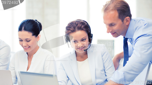 Image of group of people working in call center