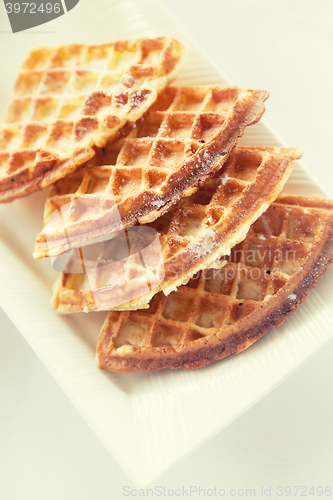 Image of close up of waffles on plate at breakfast table